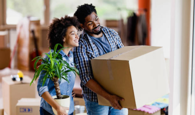 A lady holding a bouquet and a man holding a box